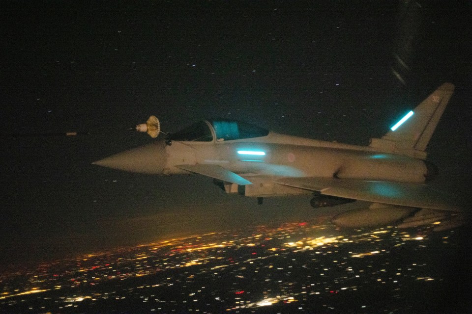 RAF Typhoon FGR4 being refueled by an RAF Voyager over Poland at night.