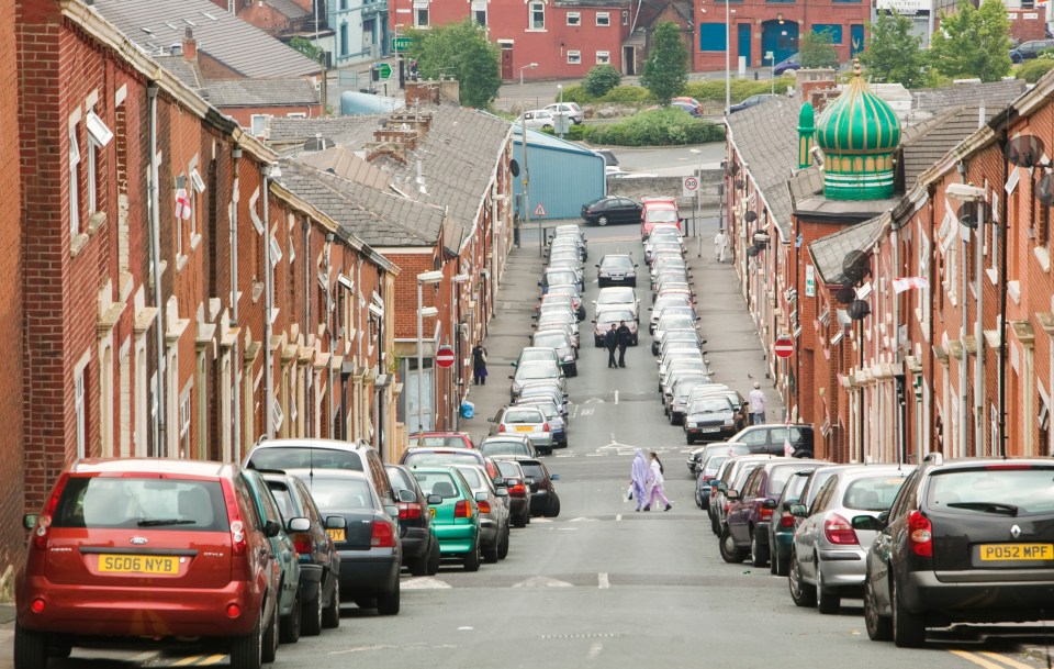 Cars parked on a street in Blackburn, UK, near a mosque.