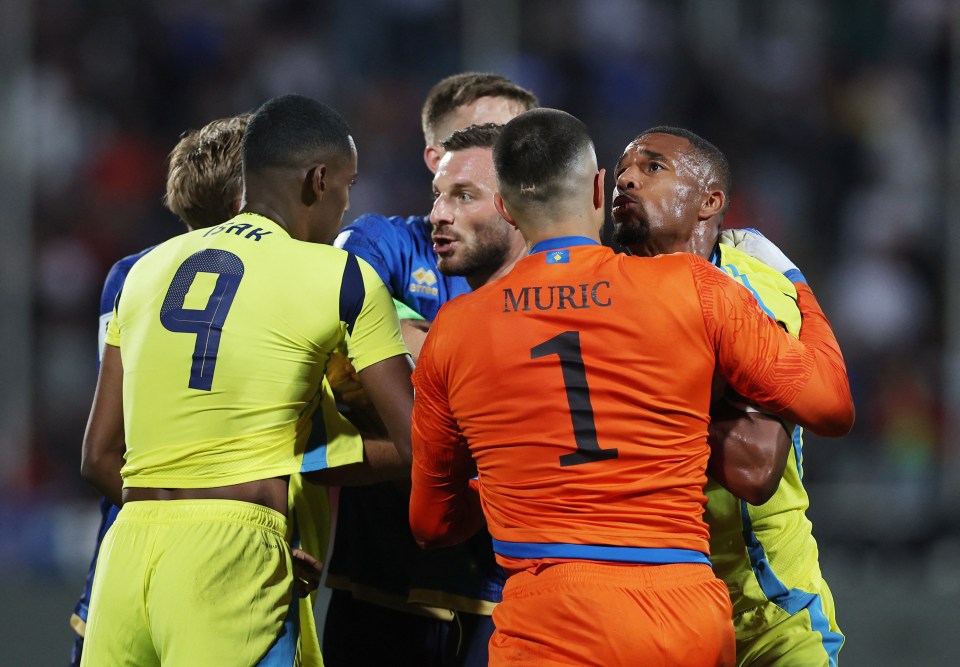 Soccer players in a heated moment during a match.