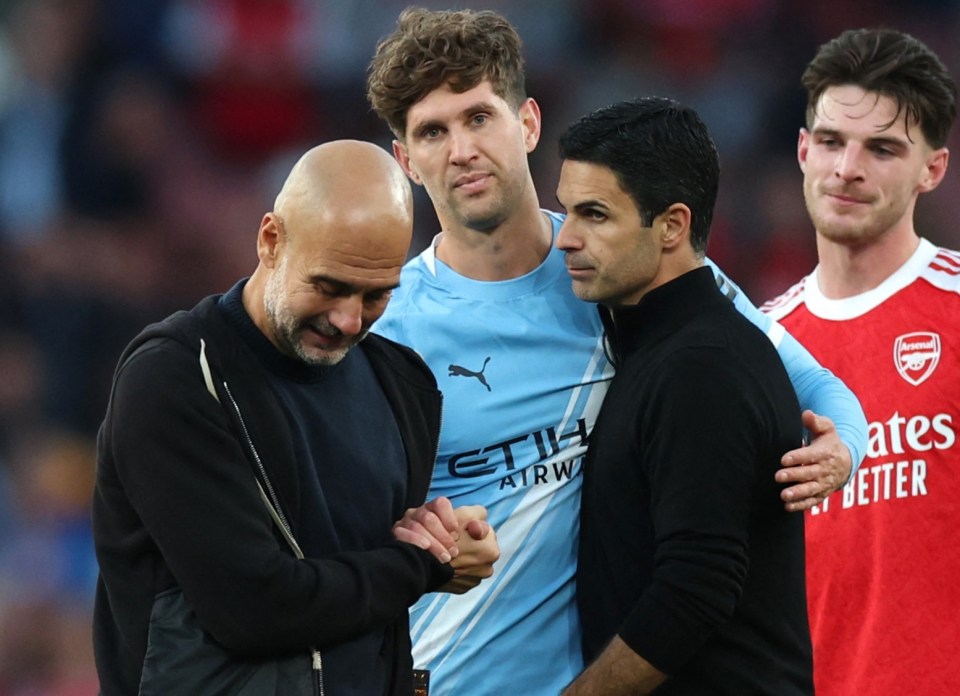 Arsenal manager Mikel Arteta and player Declan Rice with Manchester City manager Pep Guardiola and player John Stones after the match.