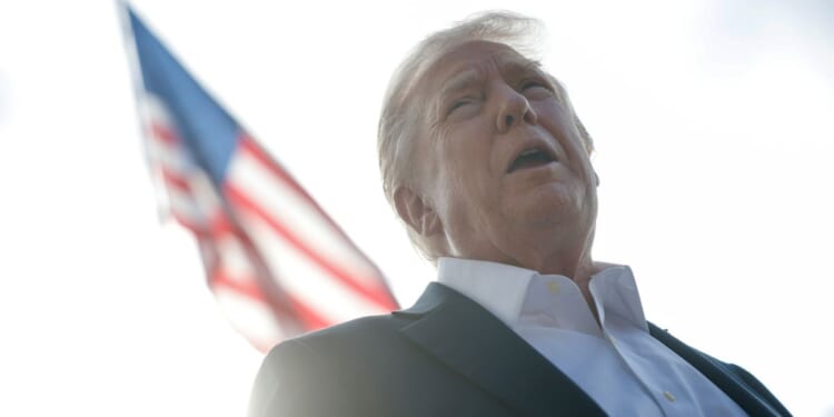 President Donald Trump speaks to members of the media as he departs the White House in Washington, D.C., on Friday.