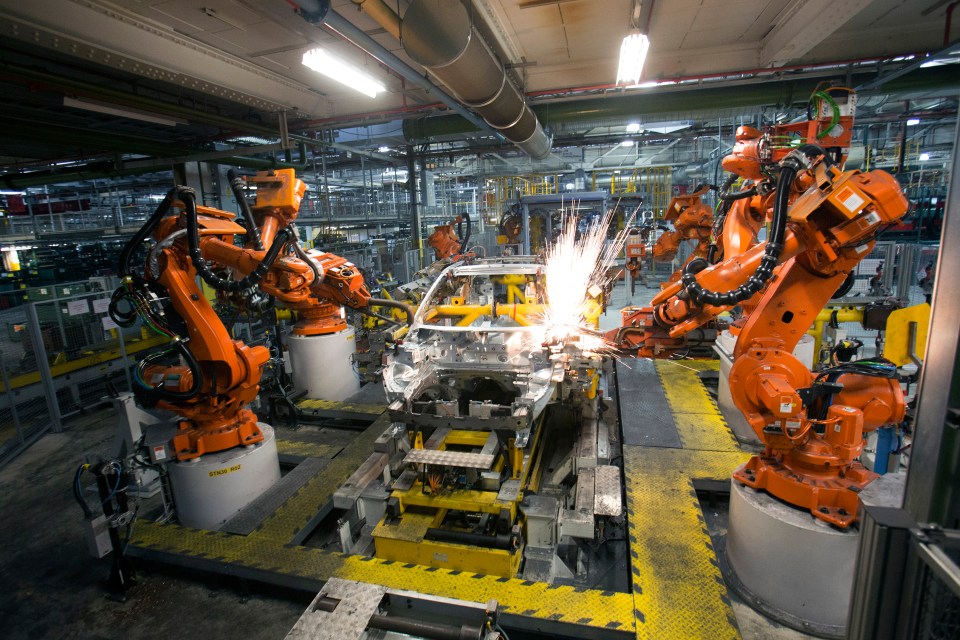 ABB Ltd. robotic arms weld the aluminum panels of an SUV automobile body shell.