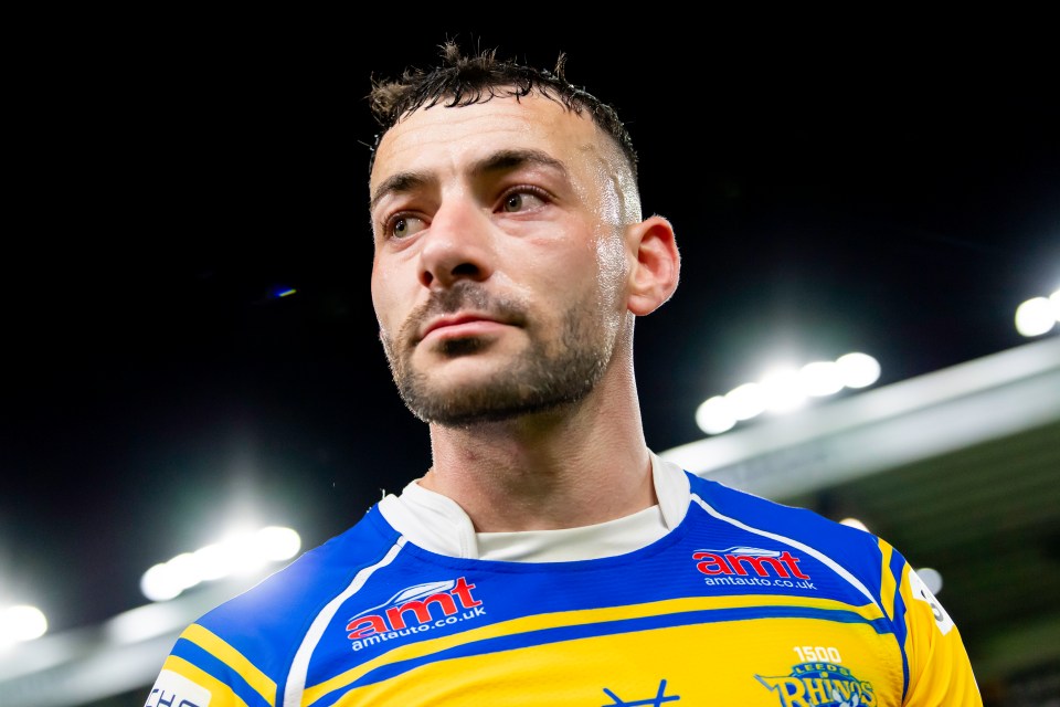 Rugby player Jake Connor in a blue and yellow jersey, looking up with a focused expression.