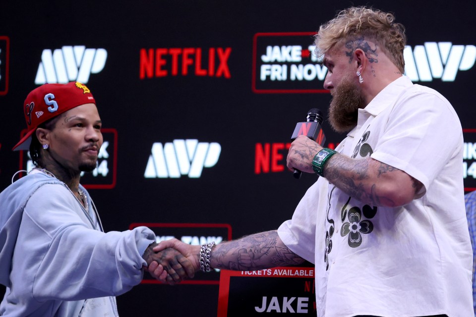 Gervonta "Tank" Davis and Jake Paul shake hands at a news conference.