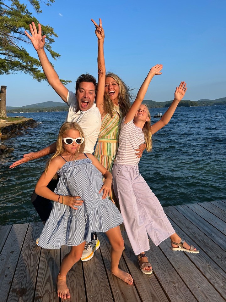 Jimmy Fallon with his wife and two daughters on a dock.