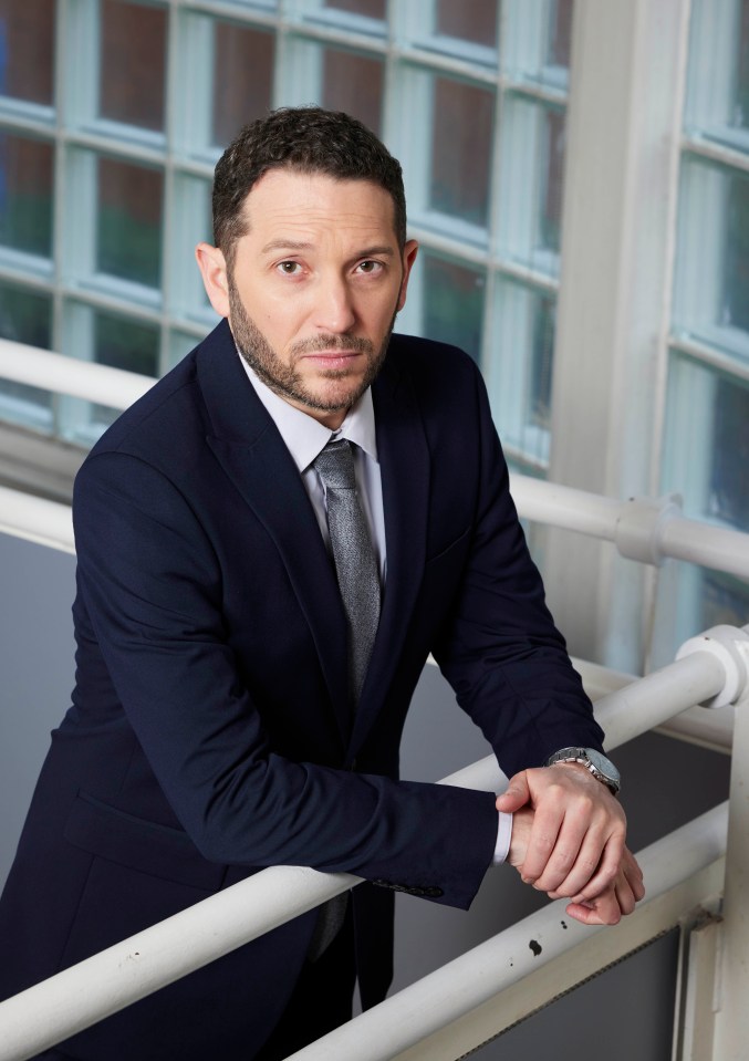 Jon Richardson in a dark suit.