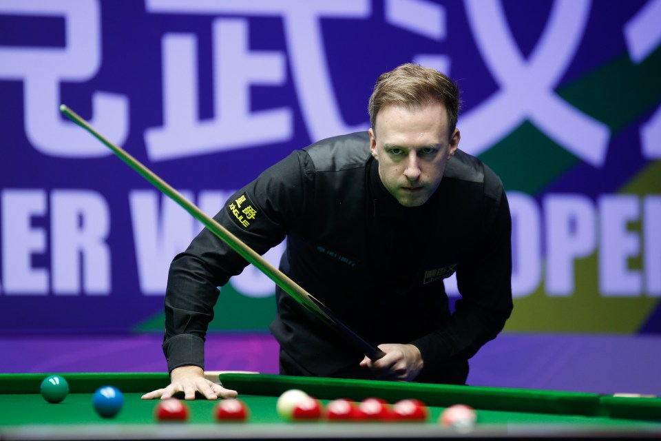 Judd Trump playing a shot during a snooker match.