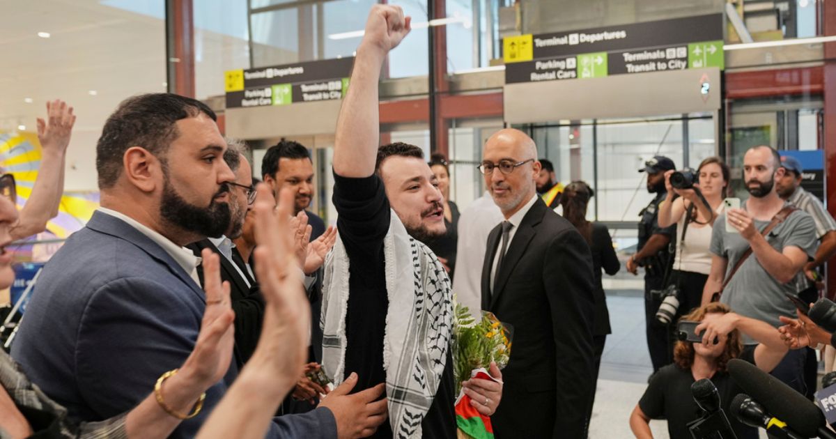 Mahmoud Khalil, center, reacts as he is greeted upon arriving at Newark International Airport in Newark, New Jersey, on June 21.