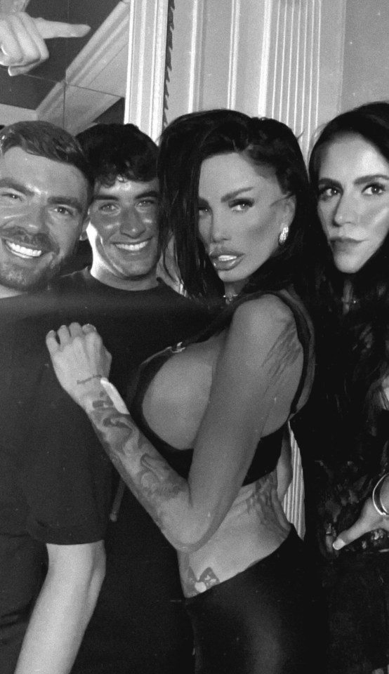 Black and white photo of Katie Price with three other people.