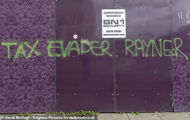 Vandals sprayed offensive graffiti in two-foot tall letters on hoardings and a wall outside her home