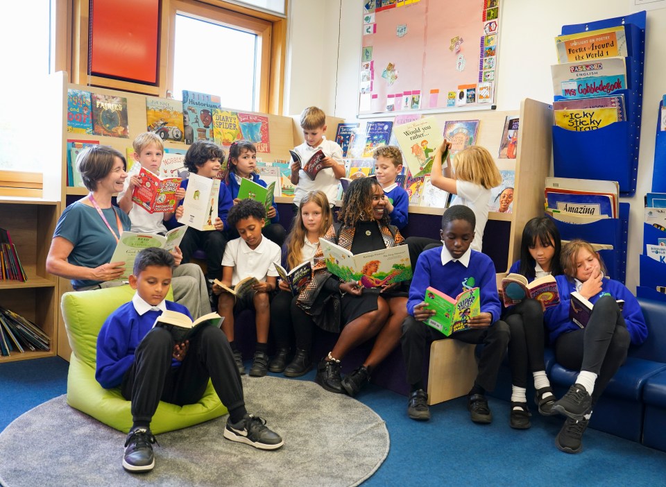 Teachers Sarah Harris and Dawn Ferdinand with pupils from Willow School reading in the library.