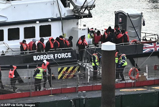 A migrant who arrived in Britain last month had been due to be sent back to Paris on Monday (Pictured: Migrants attempt to cross the Channel in January)