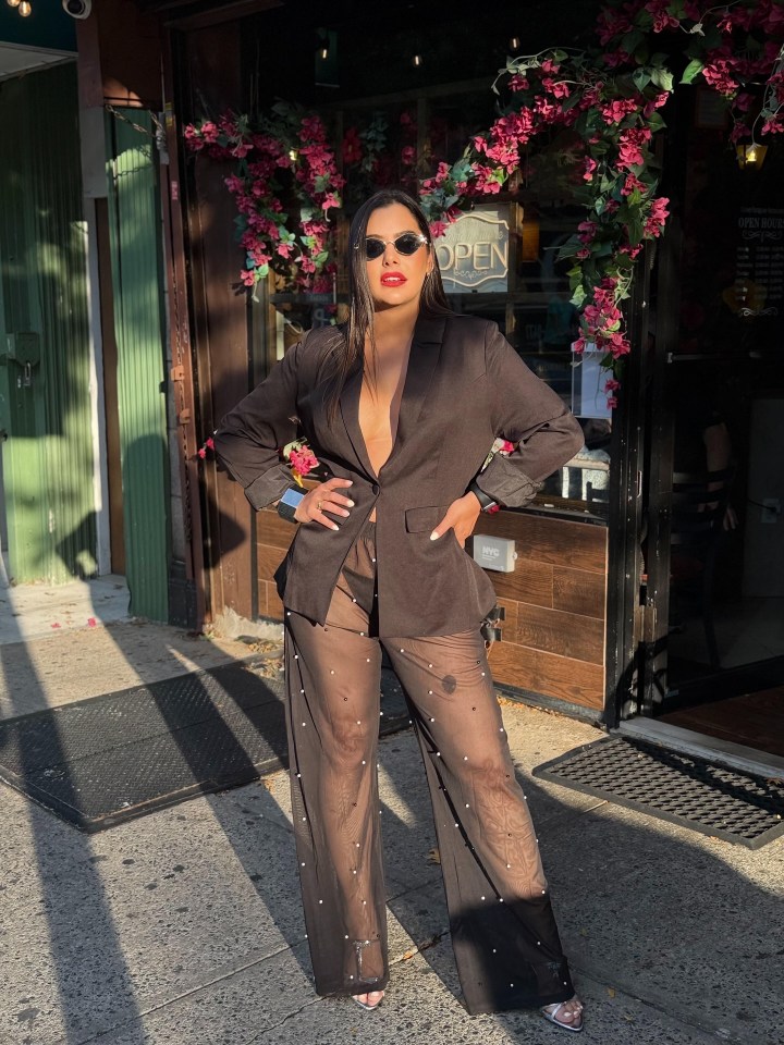 Woman in black blazer and sheer beaded pants.