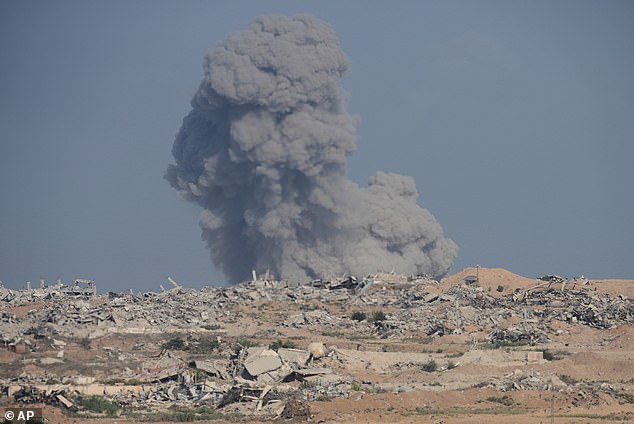 Smoke rises following an Israeli strike in the Gaza Strip today