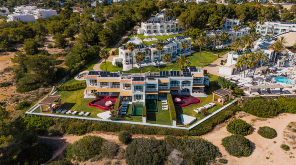 Aerial view of a resort with private villas and pools.