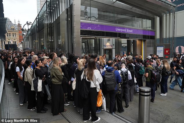 Passengers wait to enter London Liverpool Street station for Elizabeth line services today