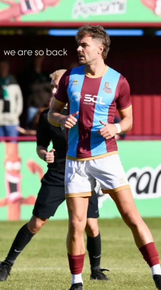 Football player in a maroon and light blue striped jersey, white shorts, and maroon socks on a field.