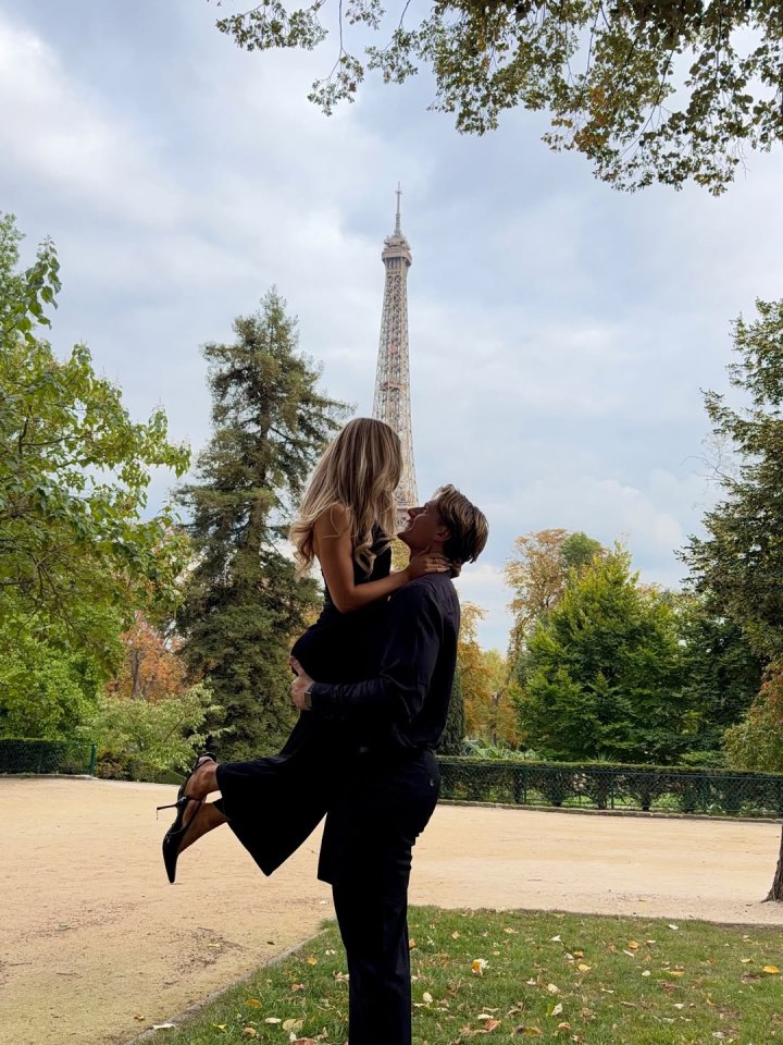 Will holding Jessie up in front of the Eiffel Tower.