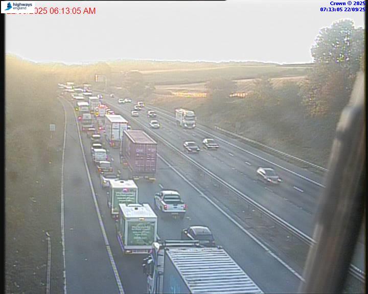 Traffic camera view of slow-moving traffic on the M62 motorway at Junction 32.