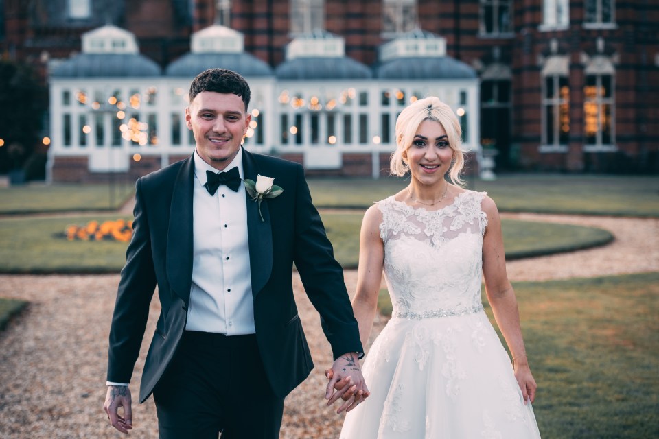 Bianca and JJ holding hands, walking at their wedding.