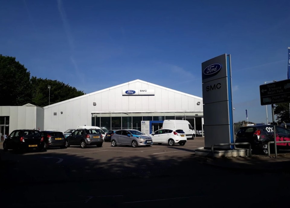 Exterior of an SMC Ford dealership with parked cars.