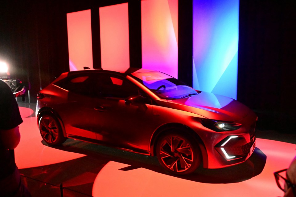 Red Renault Clio full-hybrid car on display.