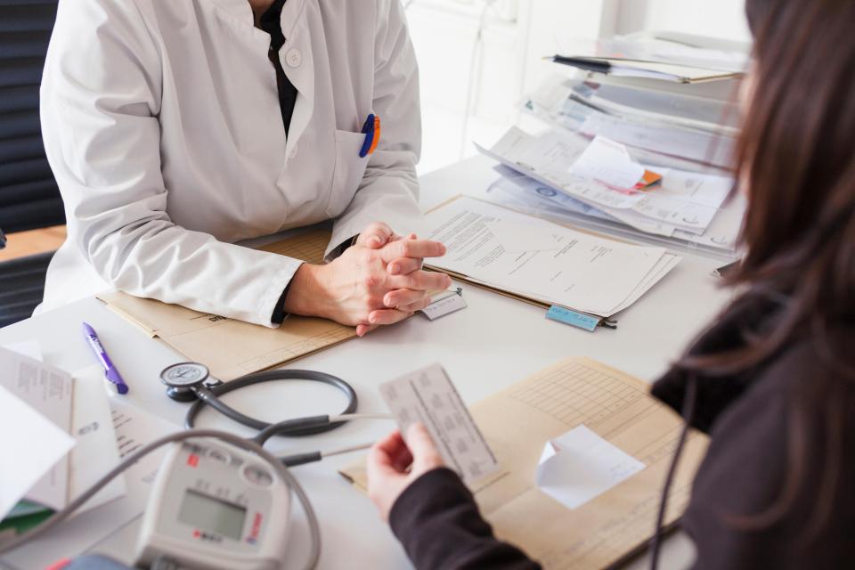 Doctor prescribing medication to a patient.