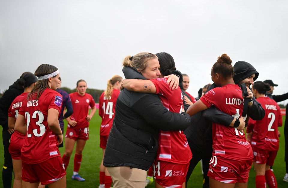 Charlotte Healy hugging a player during Bristol City's victory.