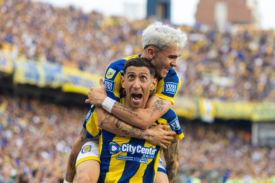 Ángel Di María of Rosario Central celebrates a goal with a teammate during a soccer match.
