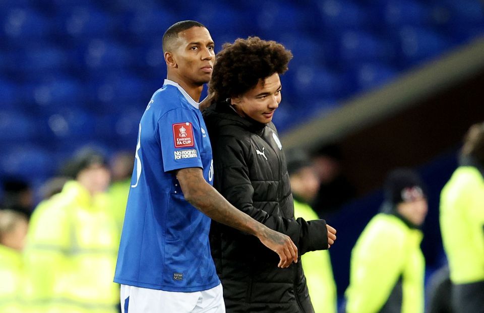 Ashley Young of Everton and his son Tyler Young of Peterborough United at a football match.