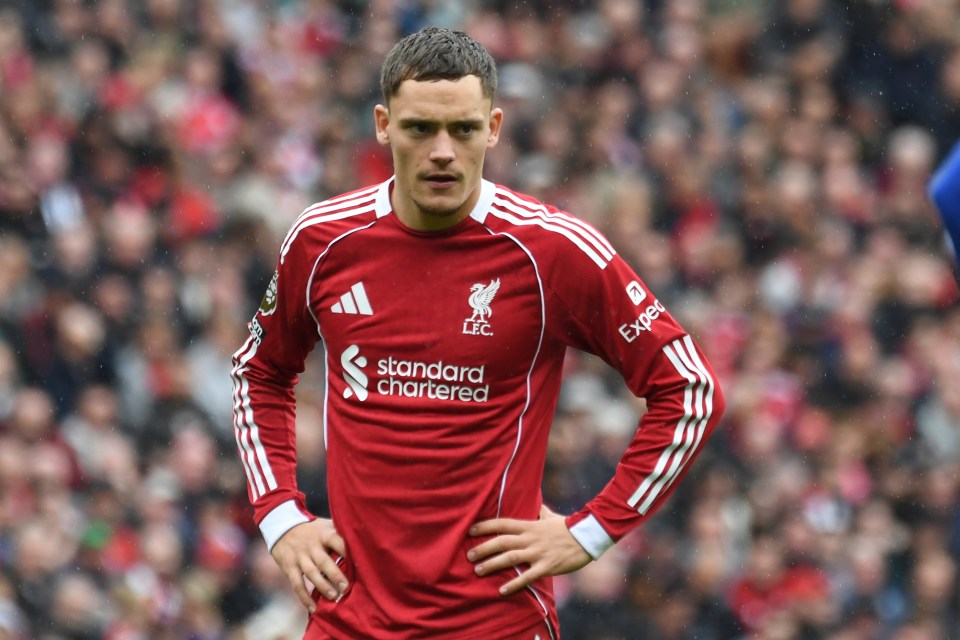 Florian Wirtz in a red Liverpool jersey looking on during a soccer match.