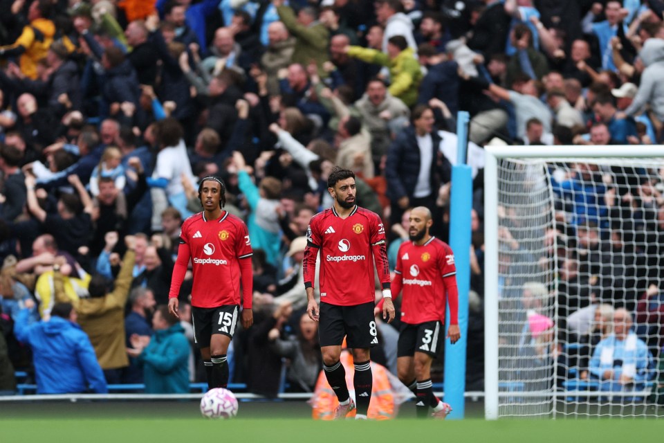 Manchester United players Leny Yoro and Bruno Fernandes react after a Manchester City goal.