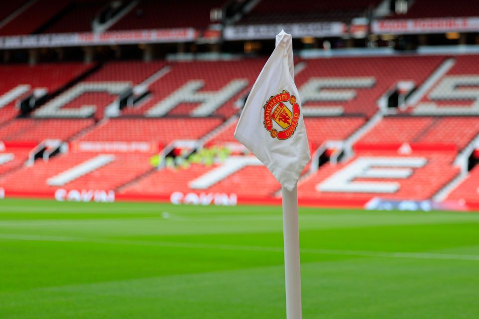 Corner flag with Manchester United logo at Old Trafford.