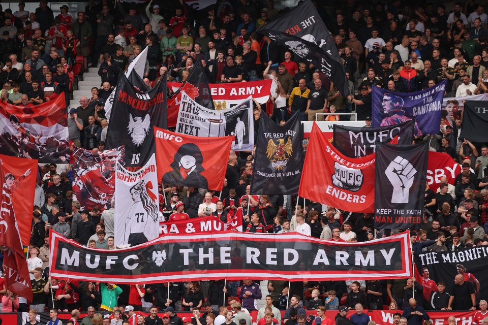 MANCHESTER, ENGLAND - AUGUST 30: Manchester United fans fly their flags in the Stretford End during the Premier League match between Manchester United and Burnley at Old Trafford on August 30, 2025 in Manchester, England. (Photo by Daniel Chesterton/Offside/Offside via Getty Images)