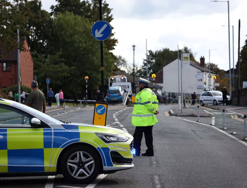 Police cordon at Guide Lane with a police car and officer visible.