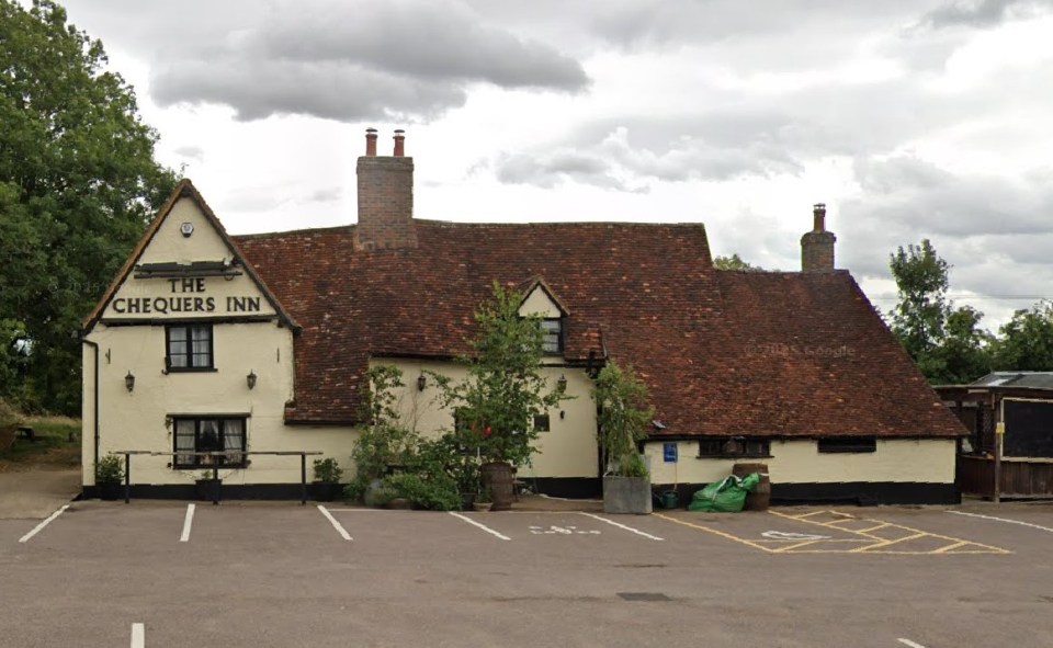 The Chequers Inn, an old building with a reddish-brown tile roof and cream-colored walls, located in Wootton.