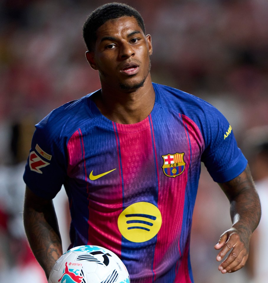 Marcus Rashford of FC Barcelona holding a soccer ball.