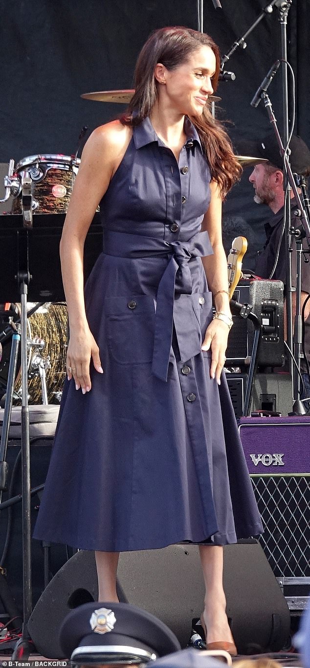 Meghan sported a £2,300 Caroline Herrera collared halterneck dress with tortoiseshell buttons and a waist-cinching sash