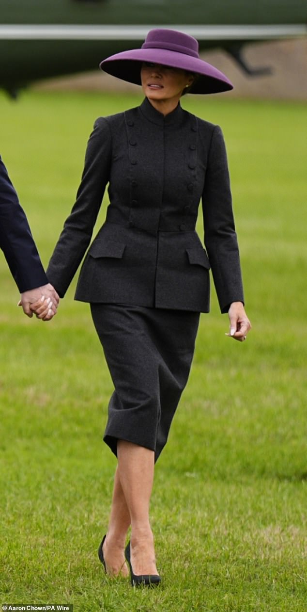 The 55-year-old looked effortlessly chic in a mauve skirt suit that flared out at the waist and fell just below her knees