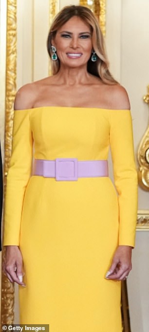 In some shots the gown appeared bright yellow, while the belt was a lilac