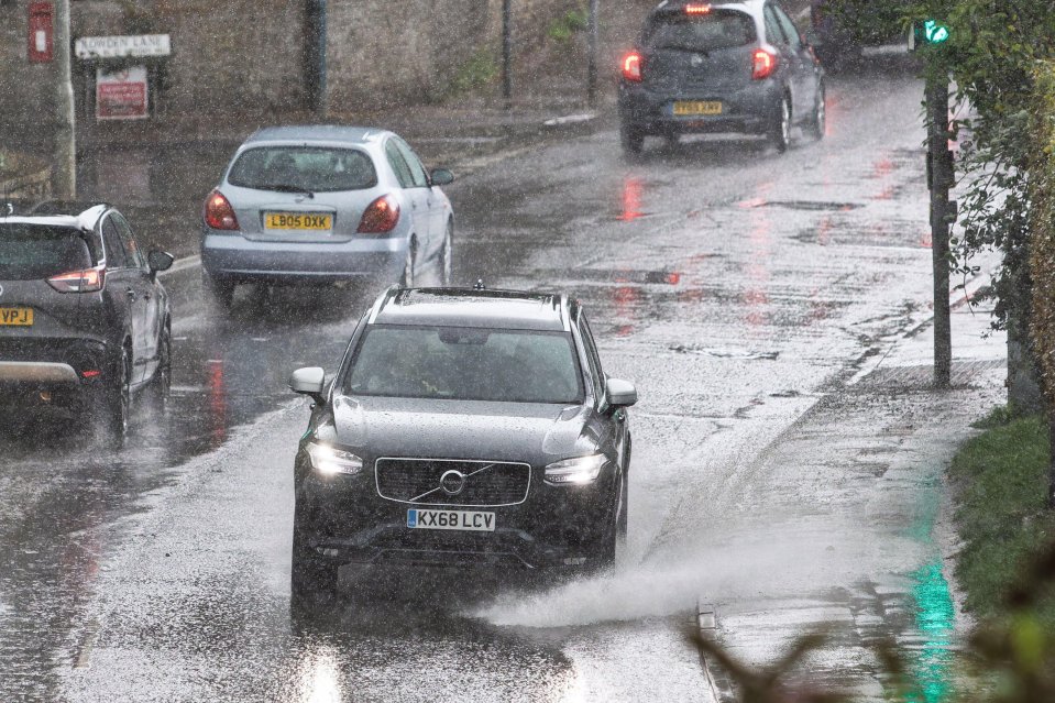 Cars driving through heavy rain.
