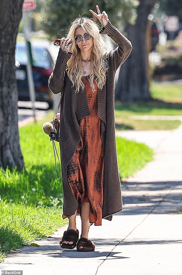 Paris Jackson flashed a peace sign while strolling in her native LA on Wednesday after publicly distancing herself from Lionsgate's fully-authorized musical biopic, Michael, about her late father