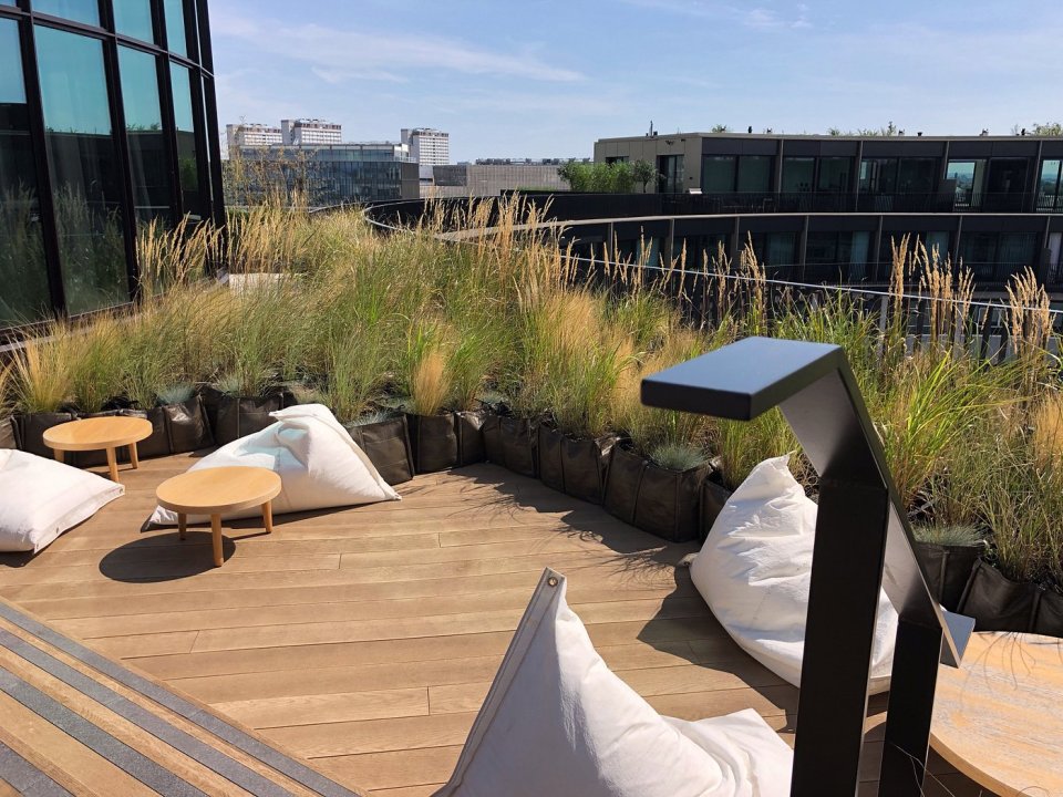 Rooftop patio with beanbag chairs and small tables.