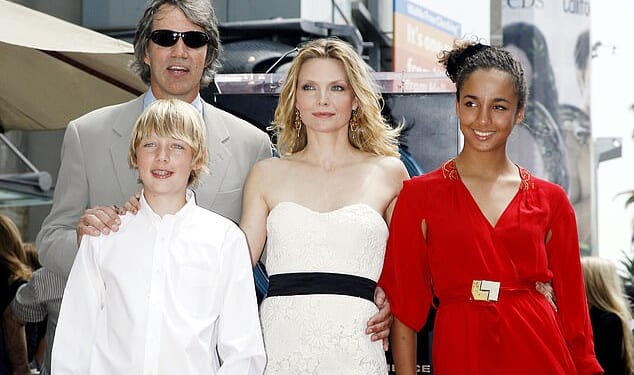 Michelle Pfeiffer revealed she has welcomed her first grandchild in a very rare interview this week - pictured 2007 with husband David E. Kelley, daughter Claudia and son John Henry