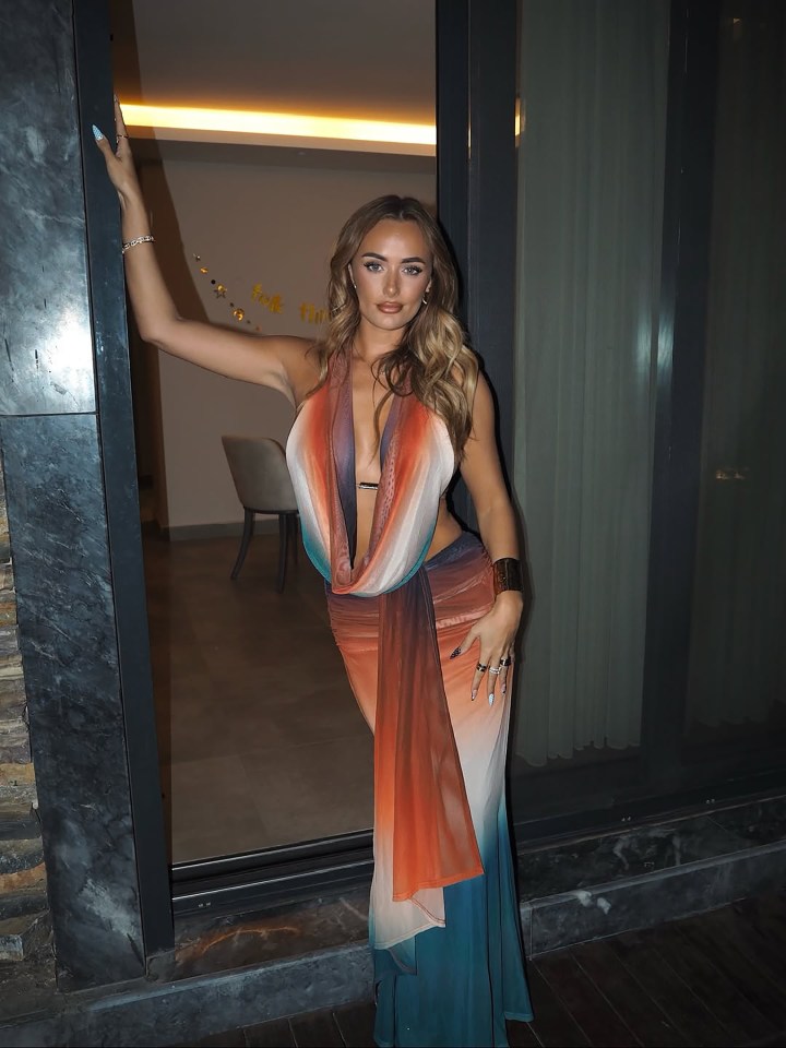 Millie Court in an ombre orange and blue halterneck gown.