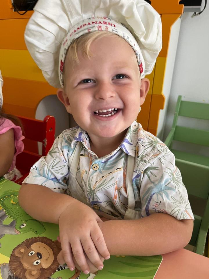Missing British boy Oliver Pugh wearing a chef's hat and patterned shirt, smiling.