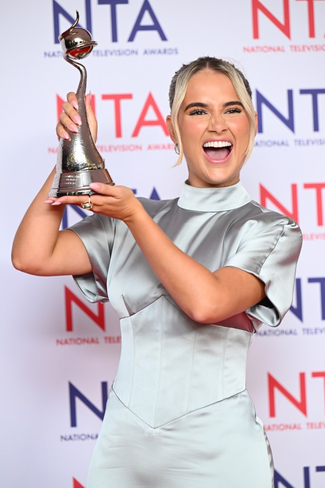 Molly-Mae Hague holding a National Television Awards trophy.