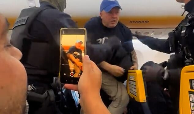 Chaotic footage shared on social media captured the scenes on board the flight which saw officers storming on to the plane