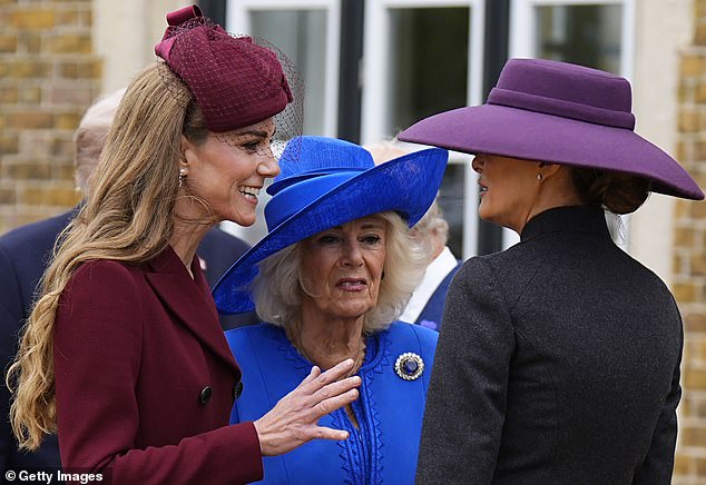 Third wheel: Kate Middleton (pictured, left) is seen animatedly chatting to First Lady Melania Trump (pictured, right) as Queen Camilla (pictured, centre) looks on at Windsor Castle today