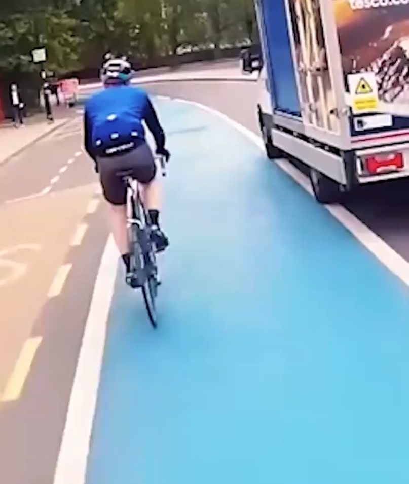 Tesco delivery van turning left into a cyclist in a bike lane.